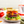 Hamburger with cheese and vegetables on a plate.